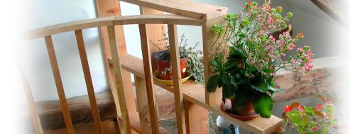 a wooden staircase with several potted plants on it at Le Gite de la Passerelle à Crévoux in Crévoux