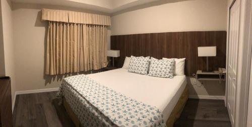 a bedroom with a large white bed with pillows at Universal-Disney Dream 606S - 1 Bedroom in Orlando
