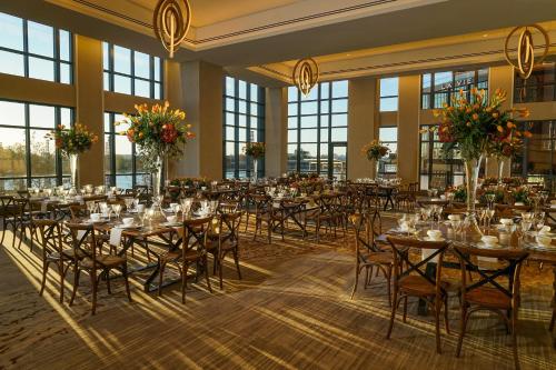 a banquet hall with tables and chairs in a room with windows at InterContinental - Washington D.C. - The Wharf by IHG in Washington