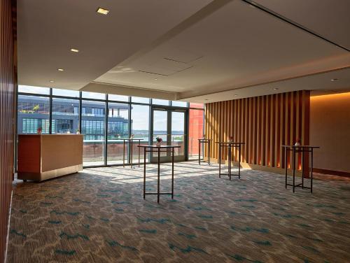 a lobby with two tables and glass windows at InterContinental - Washington D.C. - The Wharf by IHG in Washington