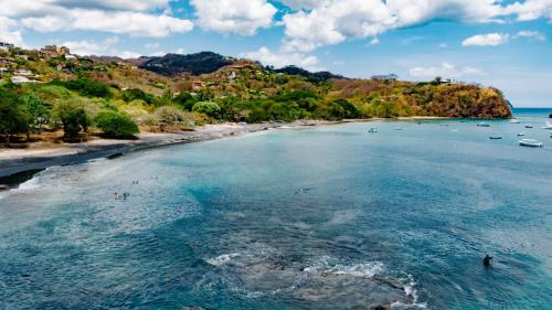 an aerial view of a beach with boats in the water at Ocotal Beach House in Sardinal