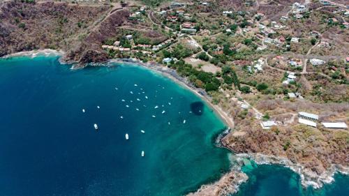 an aerial view of a beach with boats in the water at Ocotal Beach House in Sardinal