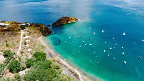 an aerial view of a beach with boats in the water at Ocotal Beach House in Sardinal