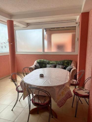 a living room with a table with chairs and a couch at Apartments Zeneva in Donji Štoj