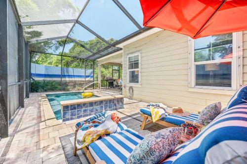 a patio with a swimming pool and an umbrella at Dog-Friendly 4BR Coastal Getaway Close to Beach in Saint Augustine