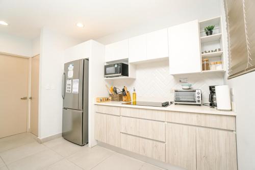 a kitchen with a stainless steel refrigerator at Casa Lapa Roja in Playa Hermosa