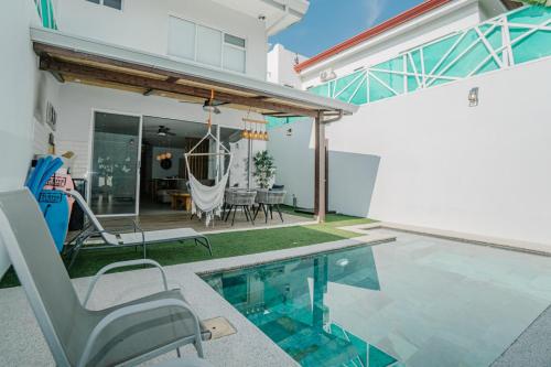 a house with a swimming pool and a patio at Casa Lapa Roja in Playa Hermosa
