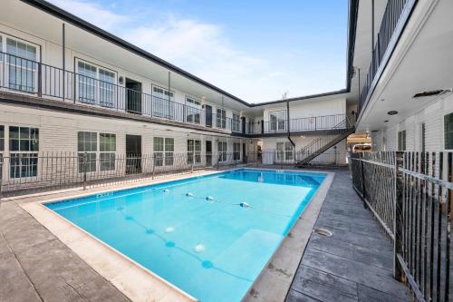a swimming pool in the courtyard of a building at Charming Getaway in Houston Heights in Houston