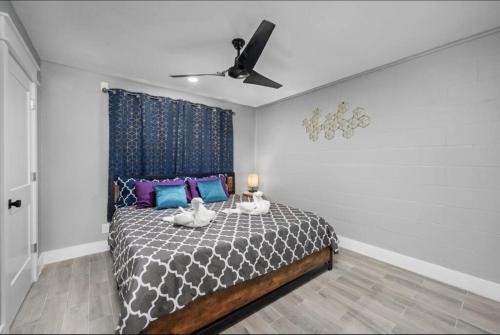 a bedroom with a bed with a ceiling fan at Charming Getaway in Houston Heights in Houston
