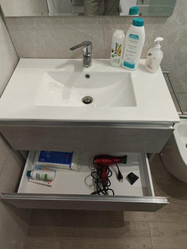 a bathroom sink with a shelf underneath it at Siderno Small in Siderno Marina