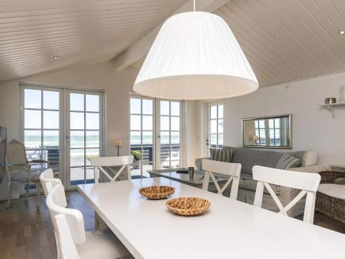 a living room with a white table and chairs at Beachfront Beauty in Hasmark - By Traum Ferienwohnungen in Otterup