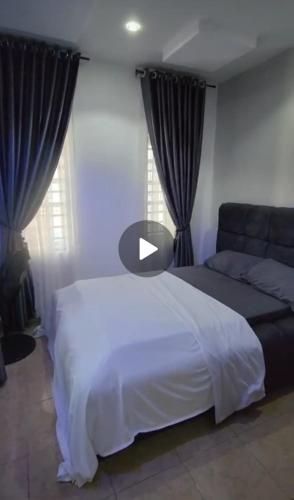 a bedroom with a white bed and a couch at Luxury 4 Bedroom Duplex at WTC Estate in Enugu