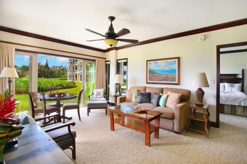 a living room with a couch and a table at Waipouli Beach Resort Exquisite Ocean Front Condo in Oceanfront H Building Sleeps 8 AC Pool in Kapaa