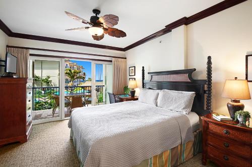 a bedroom with a bed and a balcony at Waipouli Beach Resort Exquisite Ocean View Condo With Beach Front View! AC Pool in Kapaa