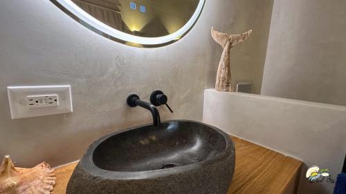a black sink in a bathroom with a mirror at CoralBay Bungalows Solarte in Solarte