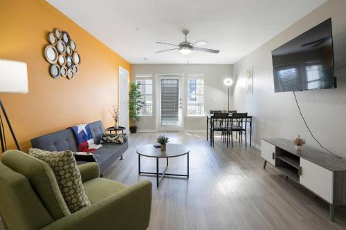 a living room with a couch and a tv at Cozy 9-Person Apt w/ WiFi near Downtown Austin in Austin