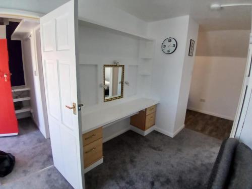 a bathroom with a sink and a mirror at The Chisel Coach House at The Bettle and Chisel in Delabole