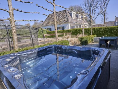 a jacuzzi tub in the backyard of a house at t Kaatsheuveltje 4 in Sprang-Capelle