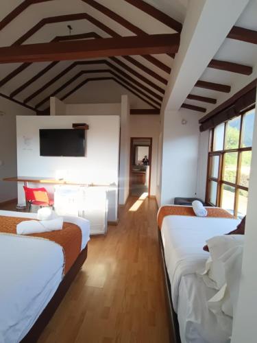 Postel nebo postele na pokoji v ubytování Hotel Santiago Diaz Piedrahita
