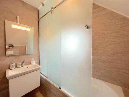 a bathroom with a white sink and a shower at Sonnenschein in Stevensweert