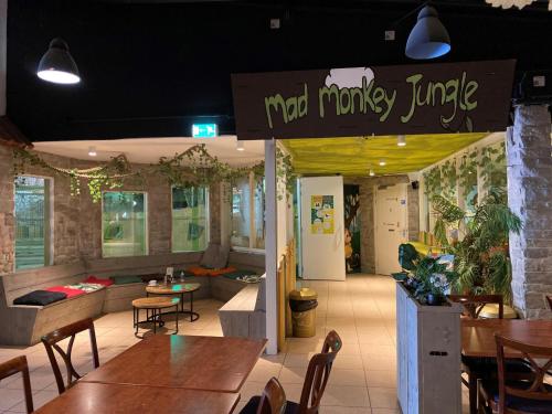 a restaurant with tables and chairs and a sign that reads magical monkey lunch at Mali in Gramsbergen