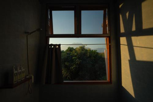a window in a room with a view of a tree at Daraga ดารกะ in Chiang Dao