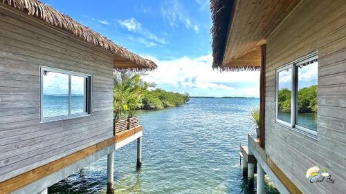 a house on the water with a view of a river at CoralBay Bungalows Solarte in Solarte