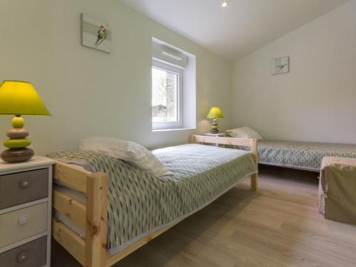 a bedroom with a bed and a window at Gîte rénové près de la mer avec jardin clos, cheminée, Wifi et équipements bébé inclus. - FR-1-306-879 in Saint-Hilaire-de-Chaléons
