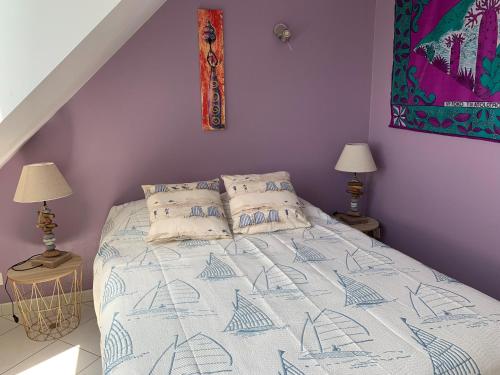 a bedroom with a bed with a blue and white comforter at Appartement familial avec parking, balcon vue mer, proche plages - FR-1-306-959 in La Turballe