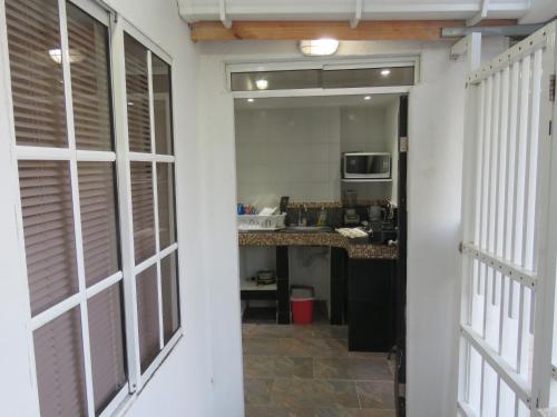 a hallway leading to a kitchen with a counter at Posada J&J Forbes - 2 in San Andrés