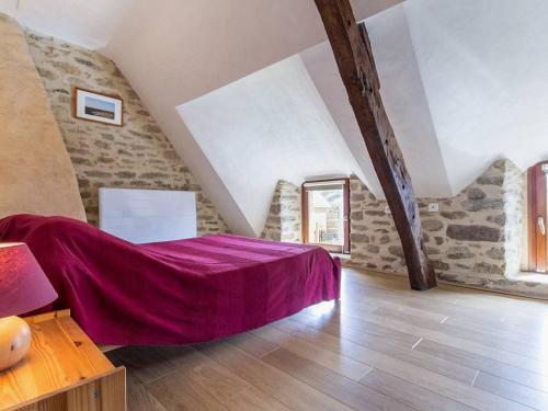 a bedroom with a purple bed in a attic at Charmante chaumière rénovée près des marais salants avec jardin clos et équipements modernes - FR-1-306-1072 in Guérande