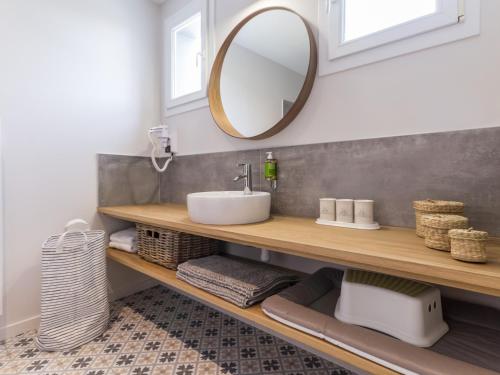 a bathroom with a sink and a mirror at Gîte cosy bord de mer avec spa à 5 min de la plage et commerces, 2 terrasses, idéal famille et bébé - FR-1-306-1192 in Pornic