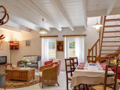 un salon avec une table et des chaises dans l'établissement Gîte familial dans le Parc de Brière - Jardin arboré, terrasse, activités ludiques, Wifi inclus - FR-1-306-1101, à Herbignac