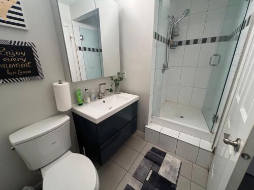 a bathroom with a toilet and a sink and a shower at Vancouver airport 7mins away joy room in Richmond