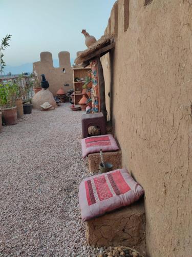 a group of beds sitting on the side of a building at Château Berbère Madame DELLAL in Taroudant