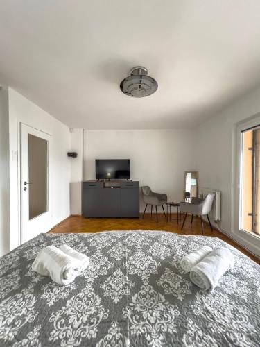 a bedroom with a large bed with two pillows on it at City View Apartment in Sarajevo