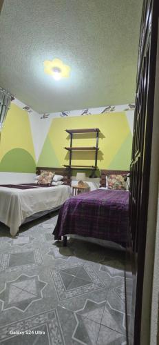 a room with two beds in a tent at Casa Mendoza Santiago Atitlan in Sololá