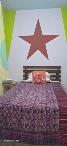 a bedroom with a bed with a star on the wall at Casa Mendoza Santiago Atitlan in Sololá