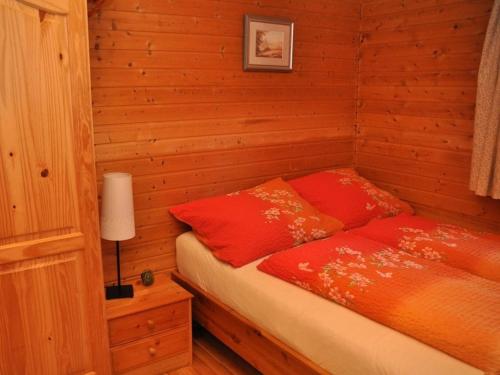 a bedroom with a bed with red pillows at Holiday home with 2 bedrooms in Meiserich