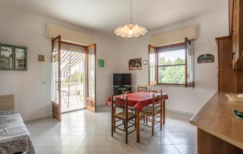a kitchen with a table and chairs and a television at 4 Bedroom Awesome Home In Modica in Modica