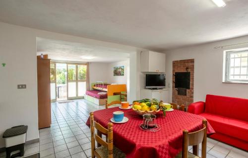 a living room with a table and a red couch at 4 Bedroom Awesome Home In Modica in Modica