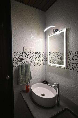 a bathroom with a sink and a mirror at The Urban Escape in Trimbak