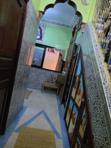 a room with a staircase with a blue arrow on the floor at Château Berbère Madame DELLAL in Taroudant
