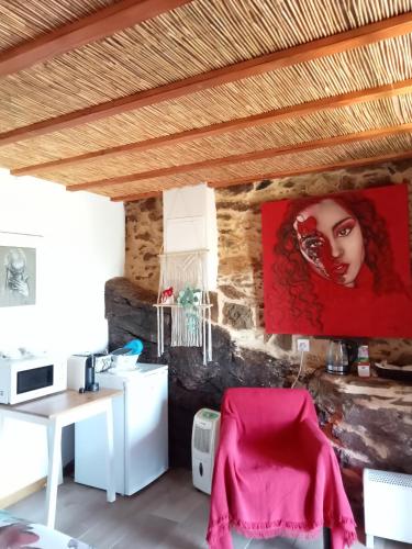 a room with a desk and a painting on the wall at Casas Coração in Codeçoso