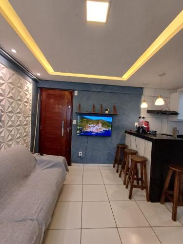 a bedroom with a bed and a kitchen with a bar at proximo ao ct do America in Parnamirim