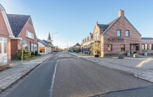 an empty street in a small town with buildings at Awesome Home In Wagenborgen With Wifi in Wagenborgen
