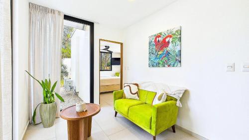 a living room with a green chair and a table at Catalina Cove 45 - Luna Piena Private Home in Brasilito