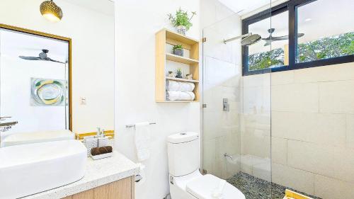 a bathroom with a toilet and a sink and a shower at Catalina Cove 45 - Luna Piena Private Home in Brasilito