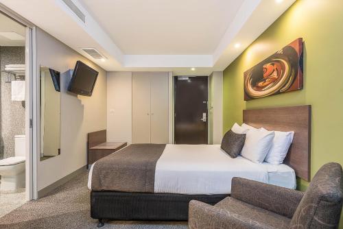 a hotel room with a bed and a couch at Mantra Melbourne Airport in Melbourne
