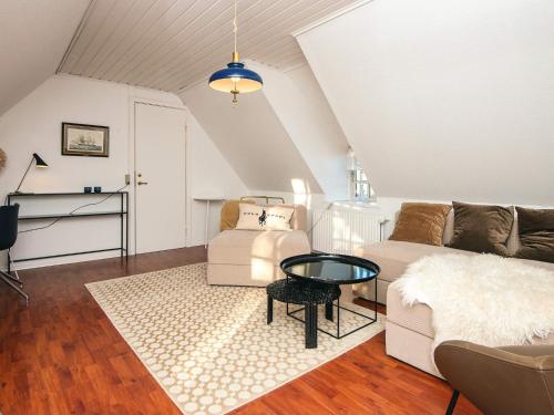a living room with a couch and a table at Hotel Strandvejen near beach in Fanø